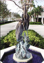 Statue of 2 great blue herons in a fountain